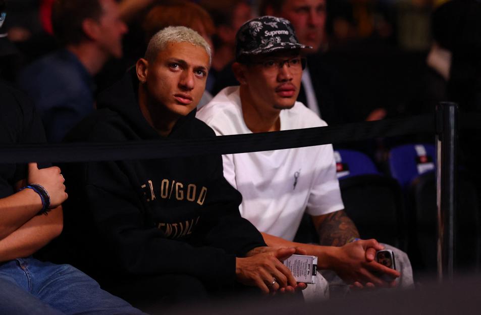 Richarlison of Tottenham Hotspur watching a UFC fight.