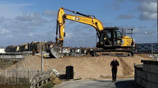 Excavator working on sea defenses in Rhyl.