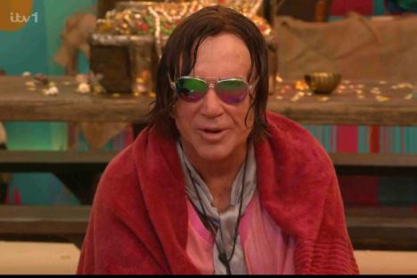 Mickey Rourke in a red towel and sunglasses.