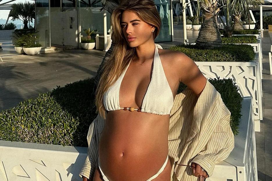 Love Island’s Arabella Chi shows off her huge baby bump as she strips down to a bikini two months before due date