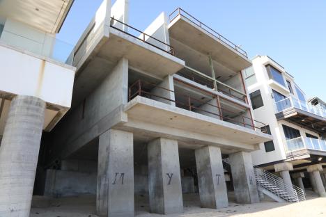 Unfinished concrete beachfront mansion.