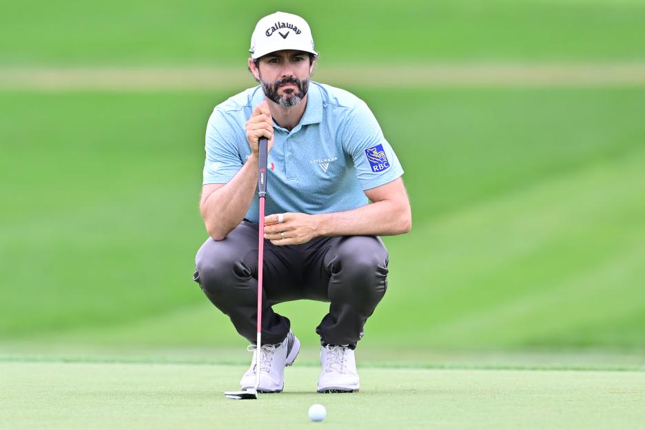 Adam Hadwin lining up a putt on the green.