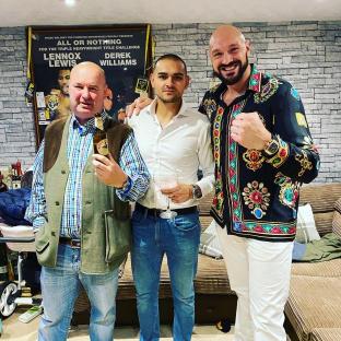 Tyson Fury's brother Roman with two men, one holding a beer.