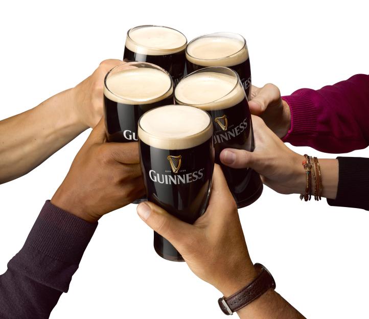 Five hands raising glasses of Guinness in a toast.