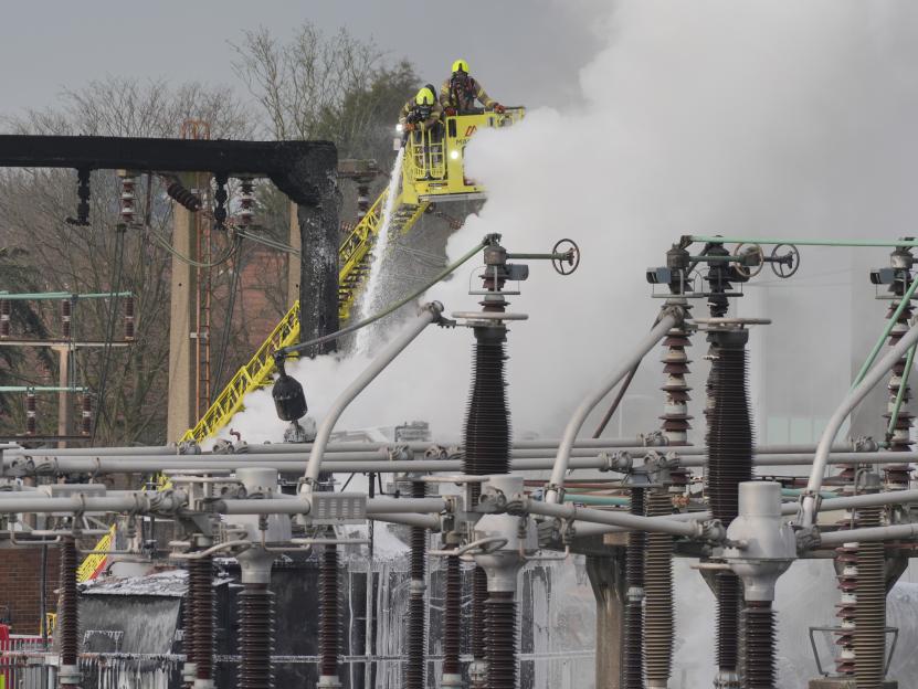 Firefighters extinguishing a fire at an electrical substation.