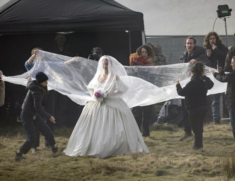 Margot Robbie in a wedding dress on the set of a Wuthering Heights film production.