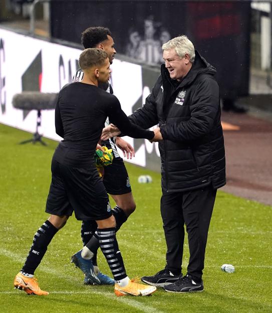 Newcastle United's Dwight Gayle and manager Steve Bruce shaking hands on the field.