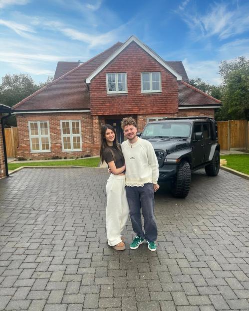 Conor Maynard and Charlotte Chilton in front of their house and car.