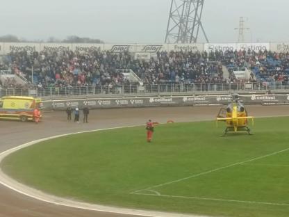 Helicopter and ambulance at a stadium.