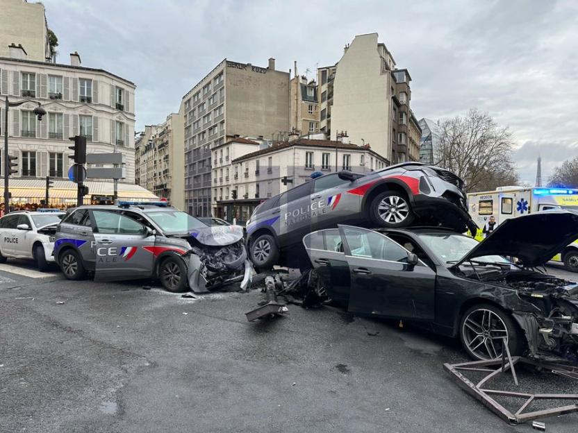 Headline: 'LIKE A FILM SHOOT' Horror moment thug crashes in high-speed police chase before cop cars smash into vehicle & fly through air injuring 13