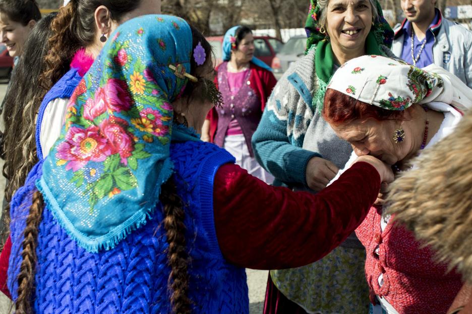 Woman kissing another woman's hand at a bride market.