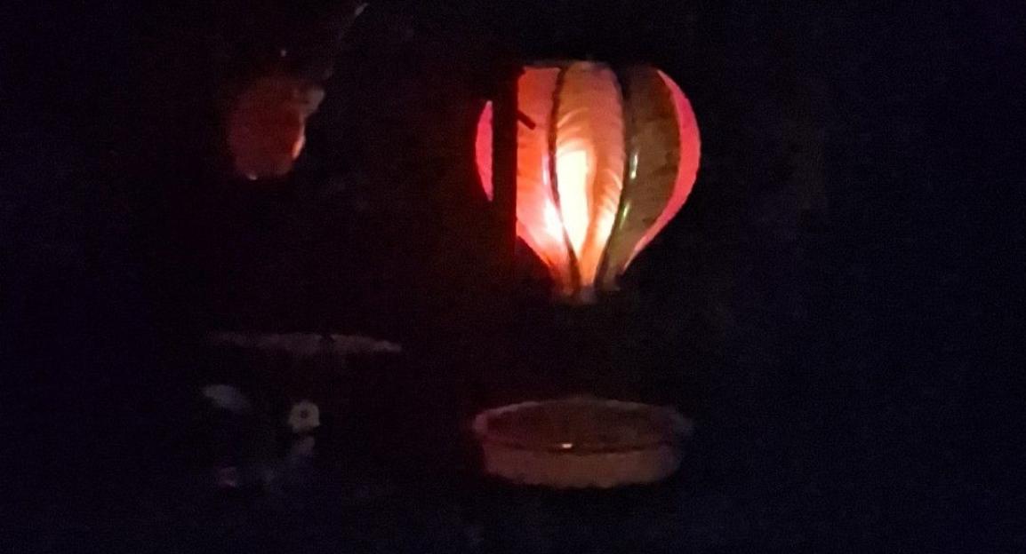 Illuminated hot air balloon solar light at night.