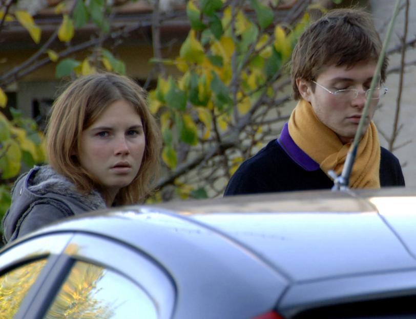 Amanda Knox and Raffaele Sollecito outside the house where Meredith Kercher was found dead.