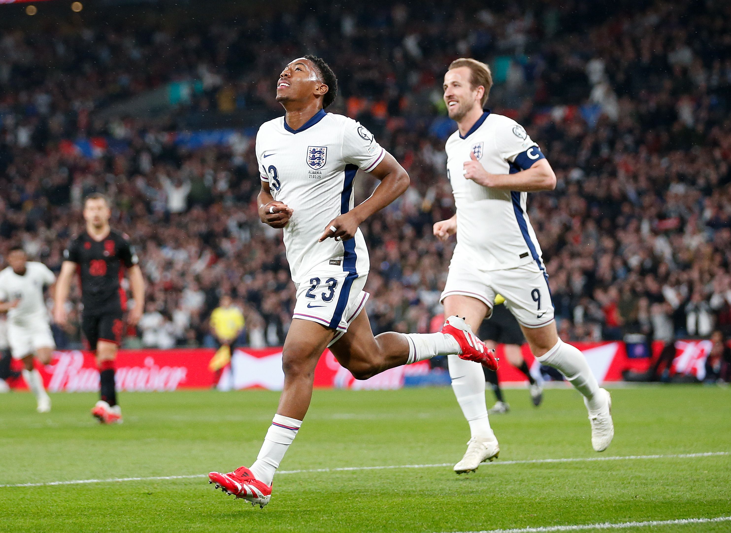 Myles Lewis-Skelly and Harry Kane celebrating a goal.