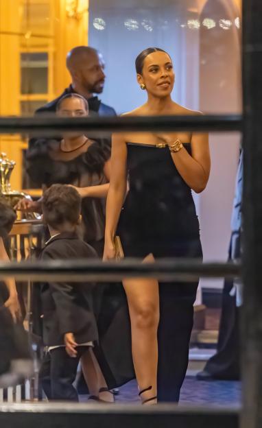 A woman in a black dress at a party.