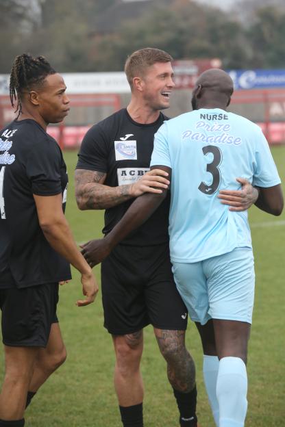 Three men at a charity football match.