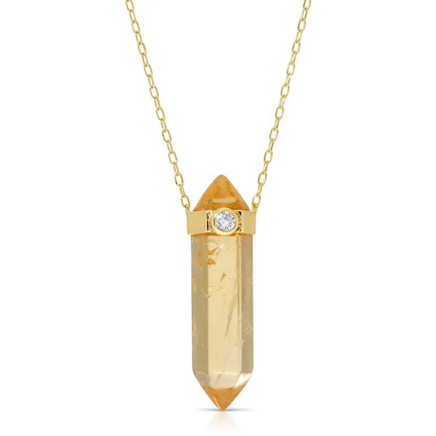 Gold necklace with yellow crystal pendant.