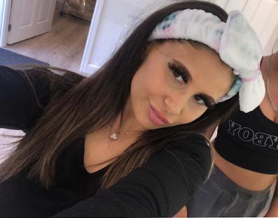 Selfie of two young women; one wears a headband.