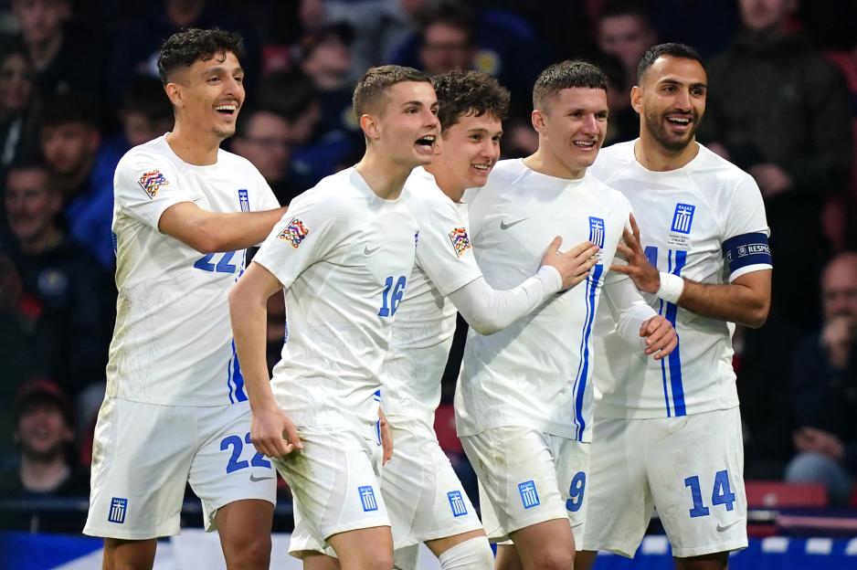 Greek soccer players celebrating a goal.