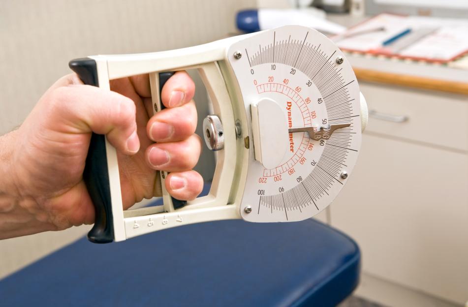 Hand gripping a dynamometer.