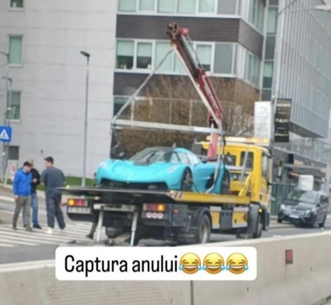 A light blue Koenigsegg being towed on a flatbed truck.