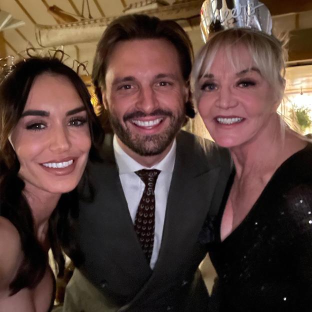 Photo of Clelia Theodorou, Tommy Cole, and a woman wearing a party hat.