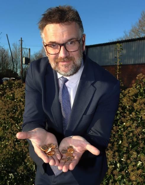 Auctioneer displaying gold coins.