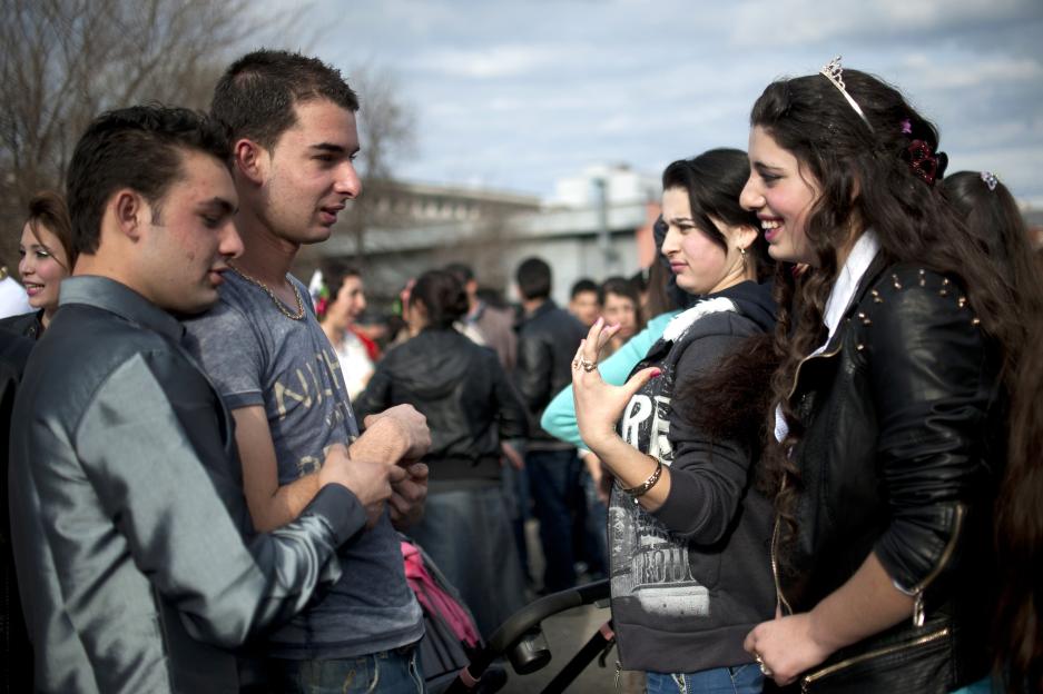 Roma teens talking at an open-air bride market.