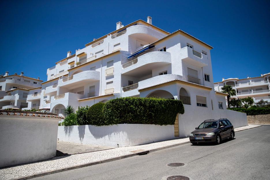 a white building with a car parked in front of it