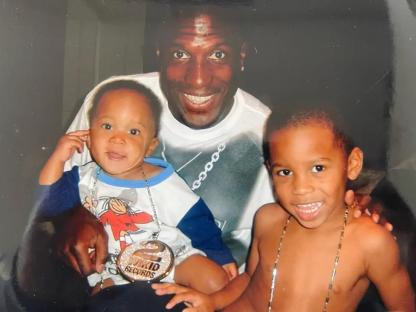 Photo of Tyrese Gibson with two young children.