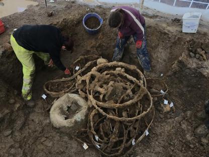 Archaeologists excavating an Iron Age hoard of metalwork.