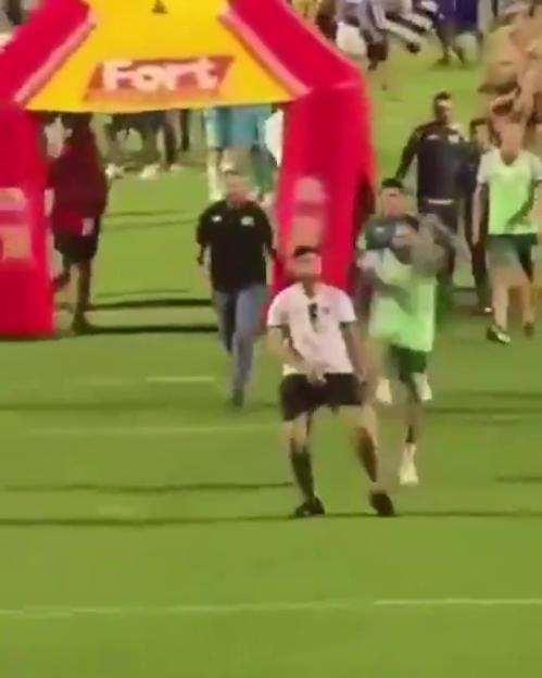 A soccer player kicks a fan.