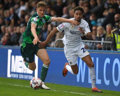 Two soccer players vying for the ball.