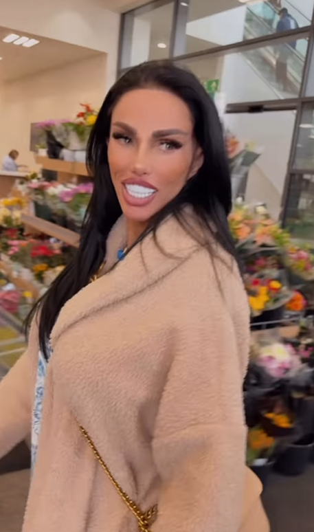 Katie Price in a pink coat at a supermarket.