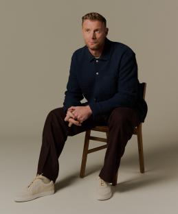 Freddie Flintoff sitting on a chair.