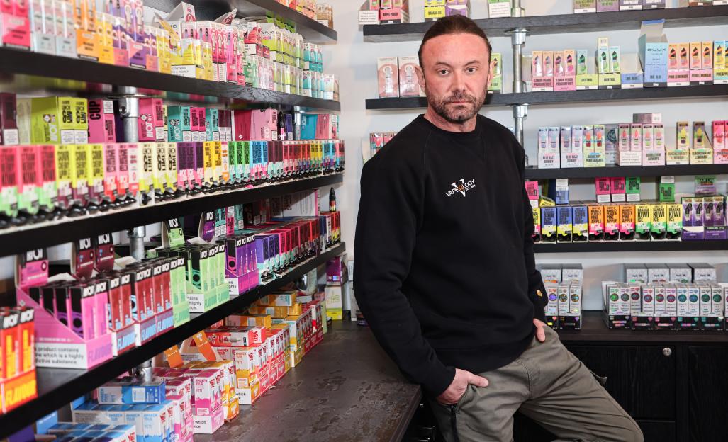 Shop owner standing in his vape shop.