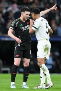 Declan Rice of Arsenal and Jude Bellingham of Real Madrid talking on the pitch.