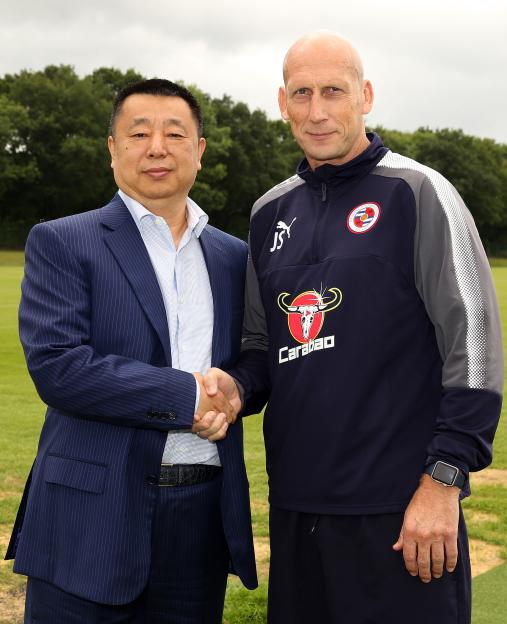 Jaap Stam shaking hands with Reading FC owner Dai Yongge.