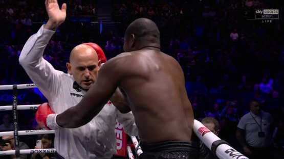 Boxing match referee signaling a foul.
